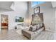 Open-concept living room featuring a wall-mounted TV, neutral walls, and stylish furniture at 1028 Orange Cosmos Blvd, Davenport, FL 33837
