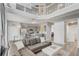Bright and airy living room leading to the kitchen, featuring modern furniture and vaulted ceilings at 1028 Orange Cosmos Blvd, Davenport, FL 33837