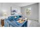 Bright living room featuring plush seating, a stylish glass table, and ample natural light at 1028 Orange Cosmos Blvd, Davenport, FL 33837