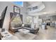 Spacious living room showcasing vaulted ceilings, modern furniture, and an eat-in kitchen at 1028 Orange Cosmos Blvd, Davenport, FL 33837