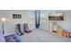 Cozy living room area featuring gaming chairs, a TV, and storage for a comfortable entertainment space at 1028 Orange Cosmos Blvd, Davenport, FL 33837