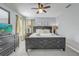 Bedroom with comfortable dark bed, gray carpet, fan, and accent decor at 1028 Orange Cosmos Blvd, Davenport, FL 33837