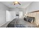 This main bedroom offers a ceiling fan and access to the ensuite bathroom and closets at 1028 Orange Cosmos Blvd, Davenport, FL 33837