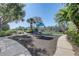 Community playground with picnic table, landscaping, and a pond at 1028 Orange Cosmos Blvd, Davenport, FL 33837