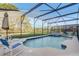 Sparkling pool with screened enclosure and poolside furniture perfect for relaxing at 1028 Orange Cosmos Blvd, Davenport, FL 33837