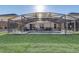 A screened in pool and green lawn provide an inviting backyard space at 1028 Orange Cosmos Blvd, Davenport, FL 33837