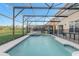Sparkling pool with screened enclosure and seating area perfect for relaxing at 1028 Orange Cosmos Blvd, Davenport, FL 33837