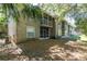 Backyard view of the screened patios and the exterior of the condo complex at 109 Reserve Cir # 201, Oviedo, FL 32765