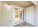 Balcony with exterior storage area looking into a well lit kitchen featuring wood cabinets and tile floors at 109 Reserve Cir # 201, Oviedo, FL 32765