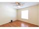 Bedroom with wood-look floors, ceiling fan, and a window bringing in natural light at 109 Reserve Cir # 201, Oviedo, FL 32765