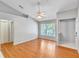 Spacious bedroom featuring a ceiling fan, window, and hardwood floors at 109 Reserve Cir # 201, Oviedo, FL 32765
