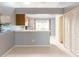 Open kitchen with breakfast bar, white appliances, and tile floors at 109 Reserve Cir # 201, Oviedo, FL 32765