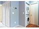 Efficient laundry area featuring a stacked washer/dryer and adjacent closet for storage in a well lit area at 109 Reserve Cir # 201, Oviedo, FL 32765