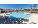 Outdoor community pool with chairs, lounge furniture, and landscaping at 109 Reserve Cir # 201, Oviedo, FL 32765