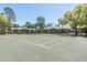 Outdoor tennis court with apartment complex and trees in the background at 109 Reserve Cir # 201, Oviedo, FL 32765