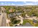 This aerial shot showcases the neighborhood, nearby retail, and the home's manicured yard and tree lined street at 111 Woodstream Ct, Maitland, FL 32751