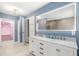 Bathroom with double vanity, large lighted mirror, and walk-in closet with custom shelving at 111 Woodstream Ct, Maitland, FL 32751