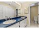 Bathroom featuring double sinks with ample counter space and tiled floors at 111 Woodstream Ct, Maitland, FL 32751