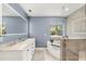 Modern bathroom features a double vanity, soaking tub, and glass shower with neutral tiling at 111 Woodstream Ct, Maitland, FL 32751