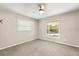 Neutral bedroom with two windows, carpet flooring, and a ceiling fan at 111 Woodstream Ct, Maitland, FL 32751