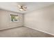 Bedroom featuring a ceiling fan, natural light from the window, and carpeted floors at 111 Woodstream Ct, Maitland, FL 32751
