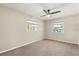 Cozy bedroom with neutral walls, two windows, and carpeted flooring at 111 Woodstream Ct, Maitland, FL 32751
