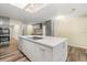 Kitchen island with white countertop and gray cabinetry, alongside stainless steel appliances at 111 Woodstream Ct, Maitland, FL 32751