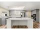 Modern kitchen with an island, stainless steel appliances, gray cabinets, and wood-look floors at 111 Woodstream Ct, Maitland, FL 32751