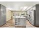 Open kitchen with an island, stainless steel appliances, gray cabinets, and wood-look flooring at 111 Woodstream Ct, Maitland, FL 32751