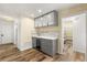 Kitchen with a dry bar, gray cabinets, glass doors, and wood-look floors at 111 Woodstream Ct, Maitland, FL 32751