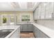 Kitchen with stainless steel appliances, gray cabinetry, a tile backsplash, and wood-look floors at 111 Woodstream Ct, Maitland, FL 32751