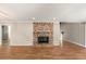 Inviting living room showcasing hardwood floors and a classic brick fireplace at 111 Woodstream Ct, Maitland, FL 32751