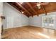 Bright living room with wood floors, vaulted ceilings with wooden beams, and a stone fireplace at 111 Woodstream Ct, Maitland, FL 32751