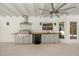 Outdoor kitchen with grill, sink, mini-fridge and overhead fan for comfortable dining at 111 Woodstream Ct, Maitland, FL 32751