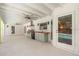 Covered outdoor kitchen includes a grill, refrigerator, sink, and ample counter space at 111 Woodstream Ct, Maitland, FL 32751