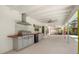 Outdoor kitchen with built-in grill, counter space and a view of the screened-in pool at 111 Woodstream Ct, Maitland, FL 32751