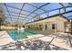 Backyard view featuring a screened pool and covered outdoor kitchen at 111 Woodstream Ct, Maitland, FL 32751
