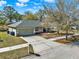 This aerial view shows the home, driveway, and surrounding neighborhood at 1137 Stratton Ave, Groveland, FL 34736