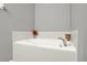 Bathroom features a white tiled soaking tub at 1137 Stratton Ave, Groveland, FL 34736