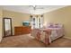 Bedroom features a ceiling fan, dresser, and mirror at 1137 Stratton Ave, Groveland, FL 34736