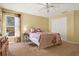 Bedroom features a ceiling fan and a window at 1137 Stratton Ave, Groveland, FL 34736