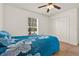 Bedroom features a ceiling fan, closet, and window at 1137 Stratton Ave, Groveland, FL 34736