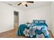 Bedroom features a ceiling fan and attached bathroom at 1137 Stratton Ave, Groveland, FL 34736