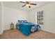 Bedroom with a window and blue floral bedding, offering ample natural light and a cozy atmosphere at 1137 Stratton Ave, Groveland, FL 34736