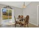 Cozy dining area with a glass-top table and chairs, and sliding glass doors to the backyard at 1137 Stratton Ave, Groveland, FL 34736