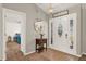 Inviting foyer featuring a decorative mirror, pendant lighting, and a view into the bedroom at 1137 Stratton Ave, Groveland, FL 34736
