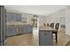 Kitchen featuring gray cabinets, stainless steel appliances, breakfast bar, and outdoor access at 1137 Stratton Ave, Groveland, FL 34736