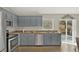 Well-lit kitchen with stainless steel appliances, ample cabinet space, and backyard access at 1137 Stratton Ave, Groveland, FL 34736