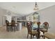 Open kitchen and dining area with tile floors, island with bar seating, and stainless steel appliances at 1137 Stratton Ave, Groveland, FL 34736