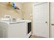 Convenient laundry room featuring modern white washer and dryer at 1137 Stratton Ave, Groveland, FL 34736